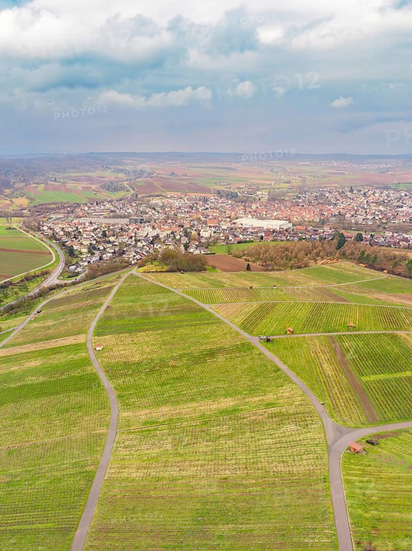 Village in a wide plain surrounded by fields under a partly cloudy sky, Großbottwar, Ludwigsburg district, Baden-Württemberg, Germany