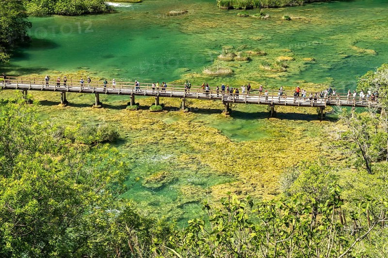 Tourists on the pedestrian bridge over the Krka River in Krka National Park, Croatia