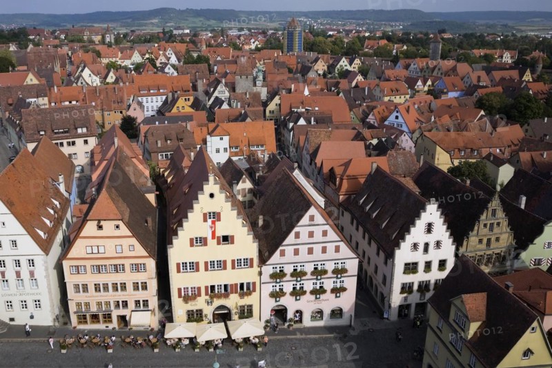 High angle view of commercial and residential buildings with traditional terracotta ceramic tiled roofs in the Market Square of the medeival town of Rothenburg in late summer, Germany