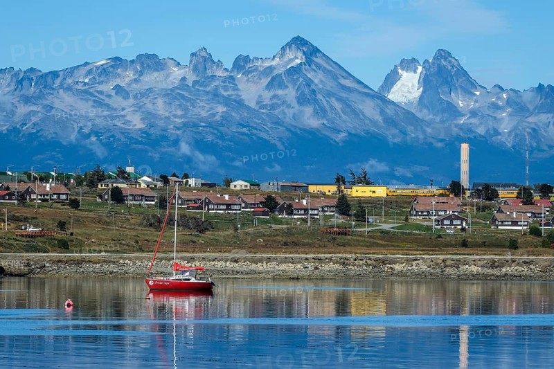 Ushuaia, Tierra del Fuego, Argentina, harbour of Ushuaia on the Beagle Channel, the Beagle Channel is a natural waterway at the southern tip of South America that connects the Atlantic Ocean with the Pacific Ocean. Ushuaia is the southernmost city in the world, the end of the world. Behind mountain range on the island of Navarino in Chile, Dientes de Navarino