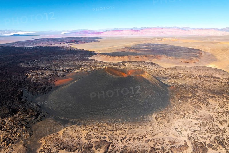 Aerial view of Antofagasta Volcano, showcasing its majestic crater and the surrounding arid landscape. Located in Catamarca, Argentina, this volcanic feature stands out in the desert scenery