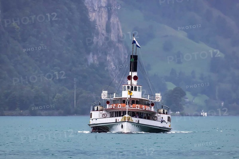 Historic paddle steamer URI travelling on Lake Uri. With the excursion boat to places of interest on Lake Lucerne. Flüelen, Canton Uri, Switzerland