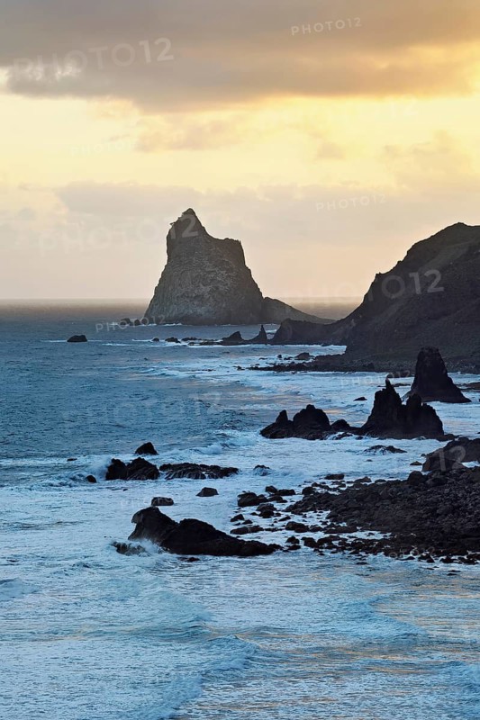 Beach of Playa de Benijo at high tide with the rock Roques de Anaga in the light of the rising sun, Tenerife, Canary Island, Spain