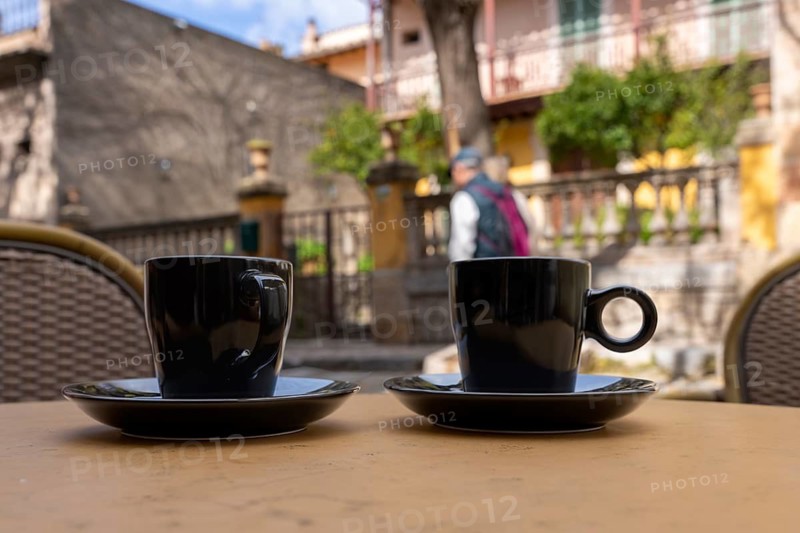 Coffee cups are on a table in a small street cafe, Valdemossa, Balearic Islands, Majorca, Spain
