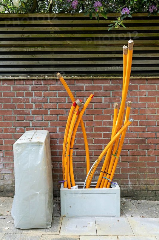 Distribution box in which empty conduits for fibre optic cables arrive and are connected, in which the actual fibre optic cable is later blown in and connected to the respective house connection. Essen, North Rhine-Westphalia, Germany