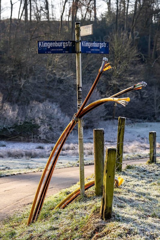 Fibre optic connection, empty conduits protrude from the ground along a dirt track, into which the actual fibre optic cable is later blown and connected to the respective house connection or distributor, provision of fast Internet in rural areas, in the south of Mülheim an der Ruhr, North Rhine-Westphalia, Germany