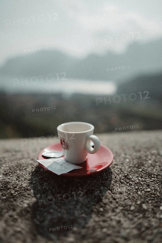 Young man taking a coffee break while riding his racing bike on Lake Garda. Sunny weather and dolce vita