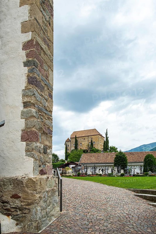 Picturesque cemetery with a view of Scena Castle, on the church hill of Scena above Merano, in the Burggrafenamt, South Tyrol, Italy, for editorial use only