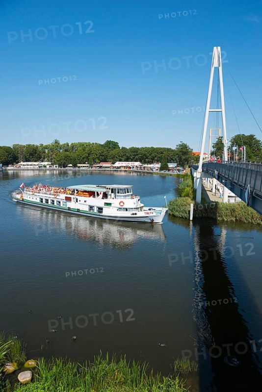 A ship sails under a modern bridge, with tourists on board, ship Talty, harbour and pier, Gizycko, Warminsko-Mazurskie, Poland