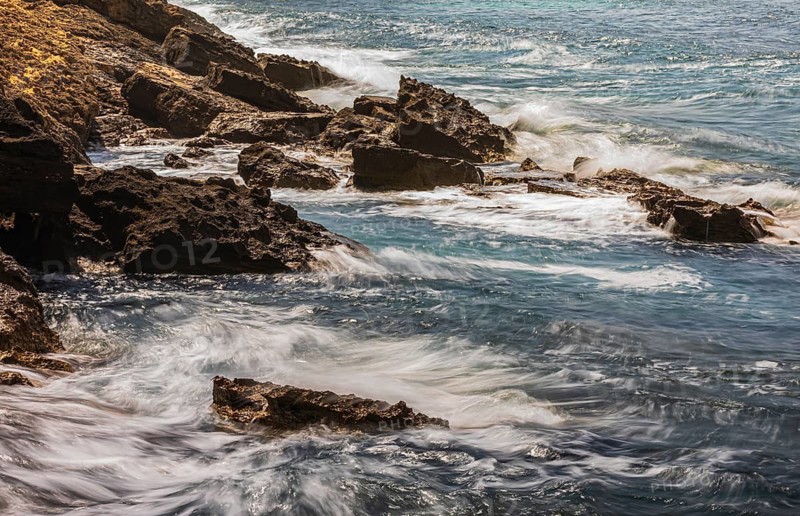 Rugged rocky coastline and foaming spray, on Stecci beach, near Capoliveri, Elba Island, Tuscan Archipelago National Park, Tuscany, Italy