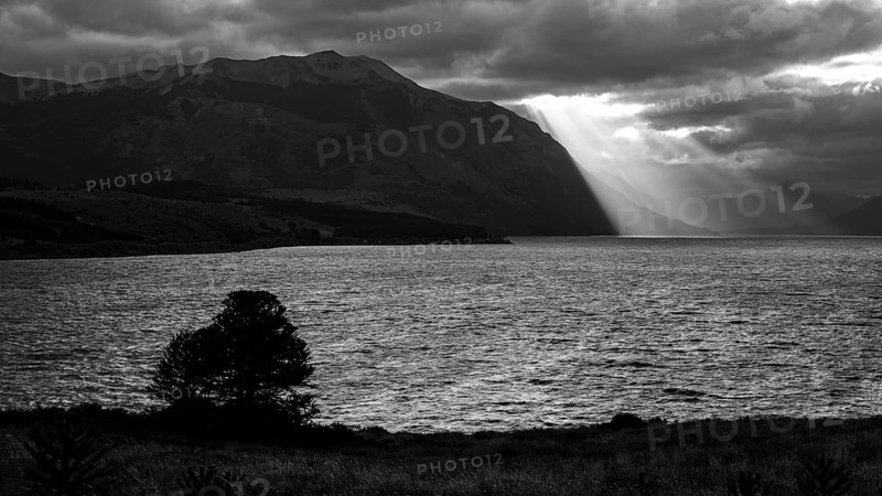 Black and white image of sunbeams and light mood at sunset at Lago Huechulafquen, Lanin National Park, Patagonia, Argentina