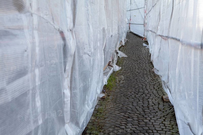 Footpath through a scaffolding with tarpaulin, Fußweg durch ein Baugerüst mit Abdeckplane