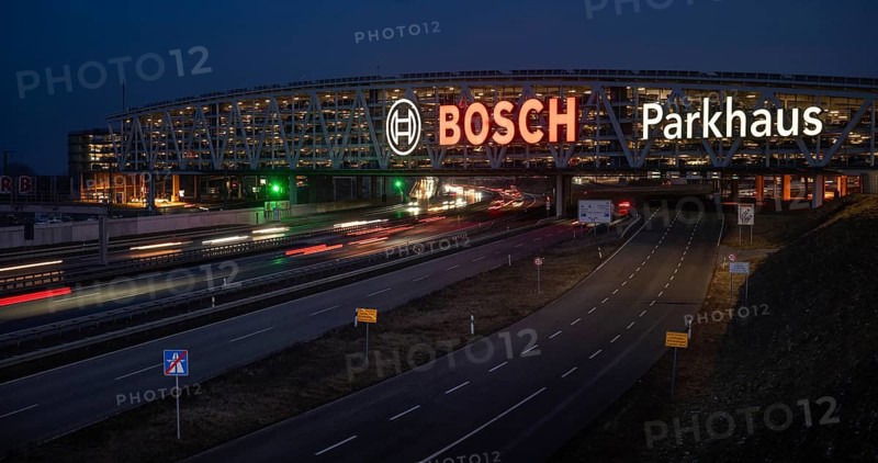 Traffic on the A8 motorway, blue hour, illuminated parking garage, Landesmesse Stuttgart, red-lit Bosch logo, second-largest logo in the world 55 meters wide, Baden-Württemberg, Germany