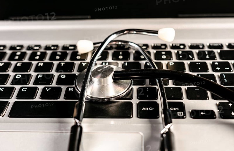 Online medical consultation concept. Stethoscope on laptop keyboard