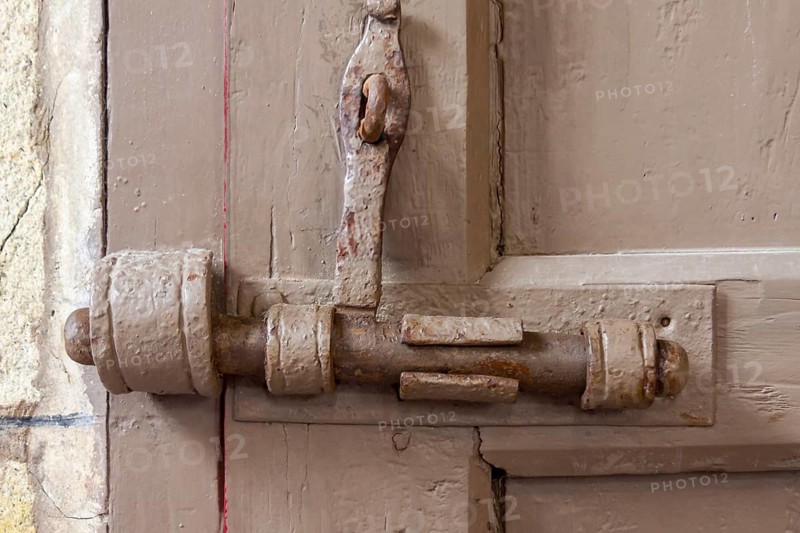 Deadbolt on an old wooden door, Brittany, France