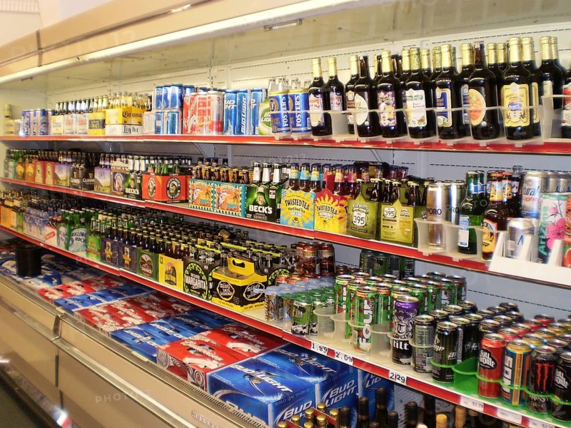 Shelf with a wide selection of colorful beer bottles and cans in a campground store shows how important beer is for American campers, Sequoia National Park, California, USA