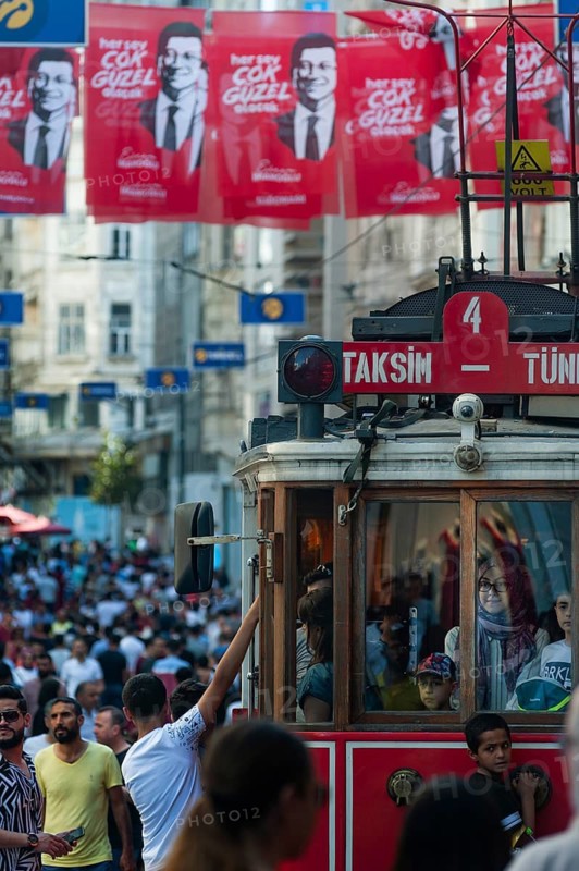 Istanbul, Turkey. June 7th 2019 Historical Taksim to Tunel Tram in a crowded Istiklal Street decorated with images of a local politician