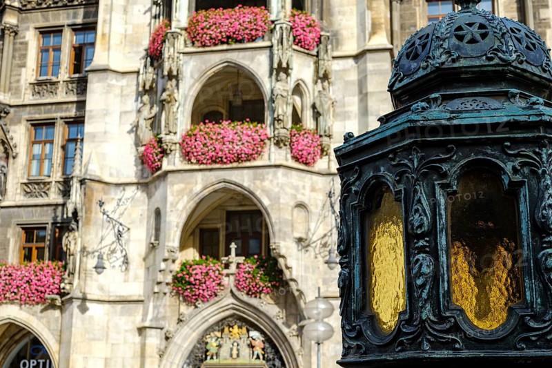 Lantern at the foot of the Marian column, in the background the main portal of the town hall, on Marienplatz in Munich, Bavaria, Germany