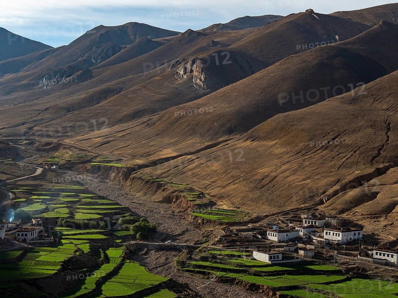 Village between green terraces, rice cultivation and agriculture in the highlands of Tibet, China