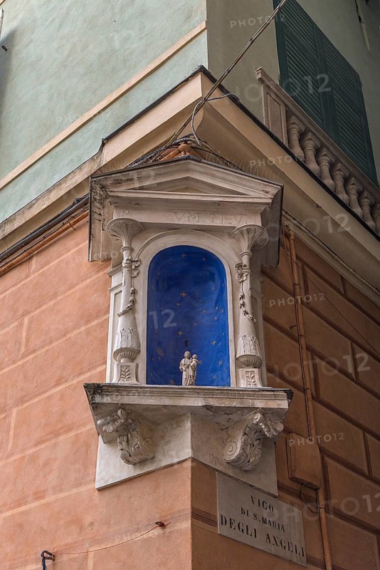Niche on a corner house with a small statue of a saint, Genoa, Italy