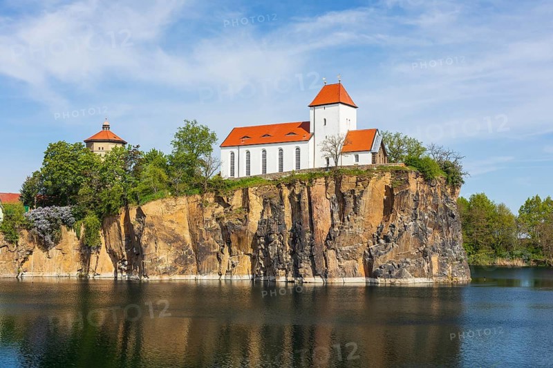 Mountain church and water tower on the Kirchberg, surrounded by the Kirchbruch quarry lake, striking view of Beucha, Brandis, Saxony, Germany