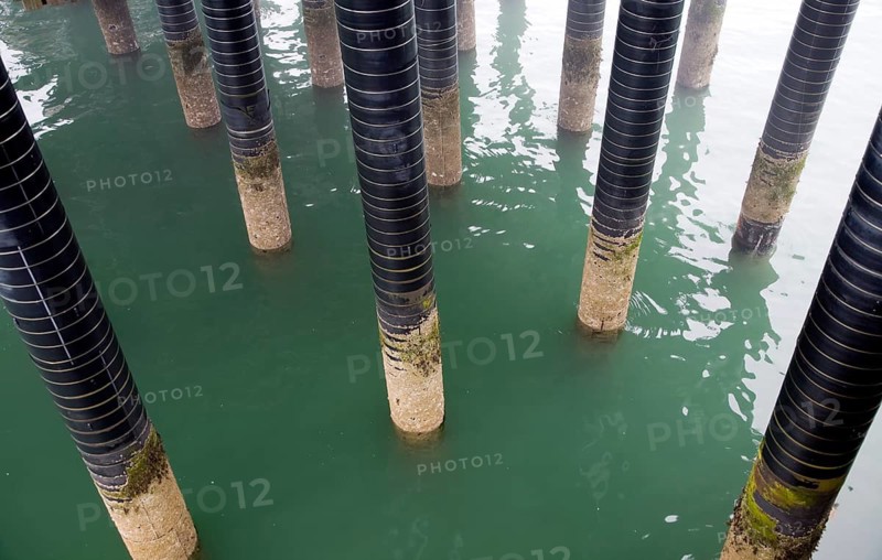 Pier support column pillars rise from sea at the seaside town of Cromer, north Norfolk coast, England, United Kingdom