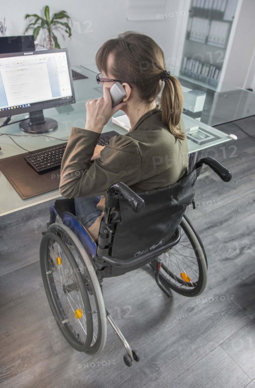Young woman in a wheelchair at her workplace, Berlin, 18/01/2017
