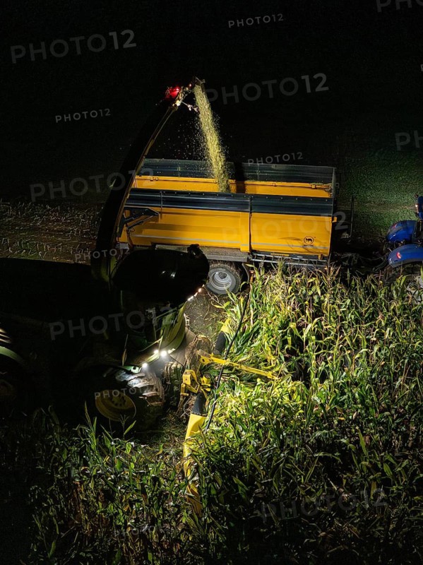 Tractors harvesting maize at night, trailer being filled, maize harvest, Dachtel, Black Forest, Germany