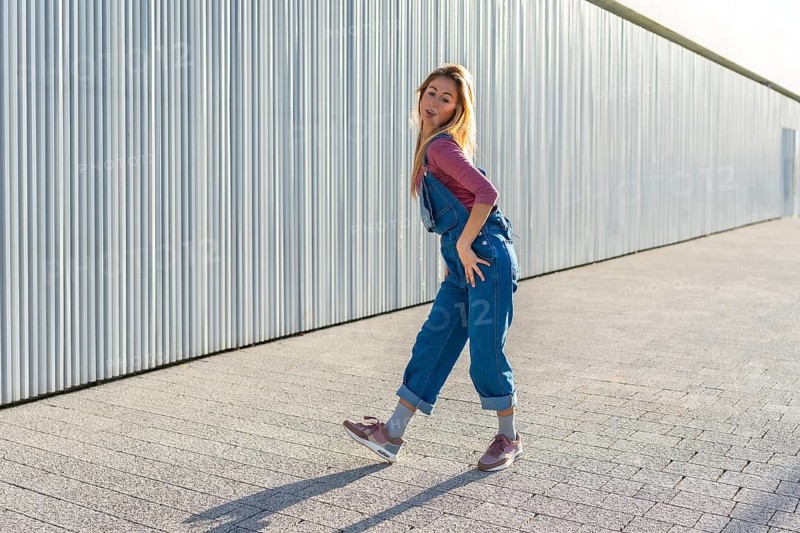 Talented young blonde woman dancing urban style outdoors, showcasing her energetic moves and passion for street dance