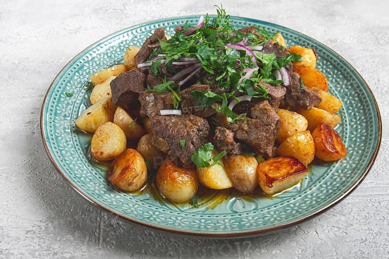 Kuyrdak, roast offal with potatoes and fresh herbs, homemade in Kazakh, no people