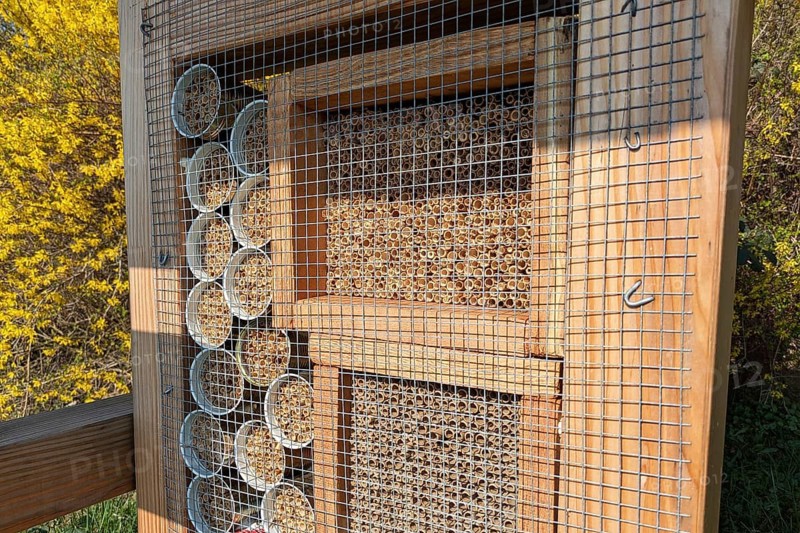 Close up of a wooden insect house hotel structure created to provide shelter for insects