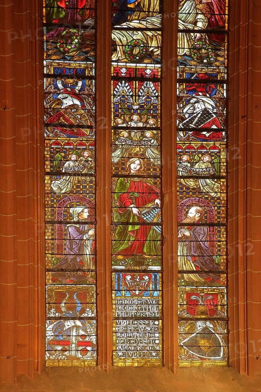 Colourful stained glass window by Alexander Linnemann 1901 with patron saint St. Cecilia for church music and organs, inscription Gloria in excelsis Deo, angels, figures, organ, stained glass, stained glass window, arts and crafts, patron saint, patron saint, interior view, Our Lady, town church, Friedberg, Wetterau, Hesse, Germany