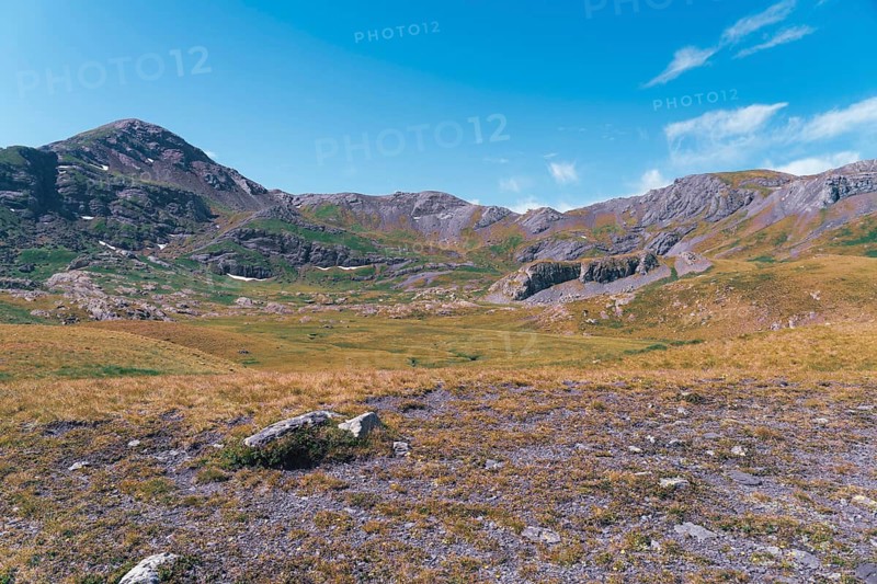 Journey through the lush terrain on hiking trails toward the stunning Ibones de Anayet, located in the picturesque landscape of Huesca, Spain