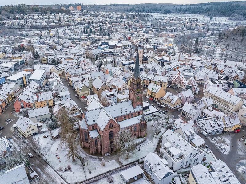 Townscape in winter with snow-covered roofs and a central church, Nagold, Black Forest, Germany