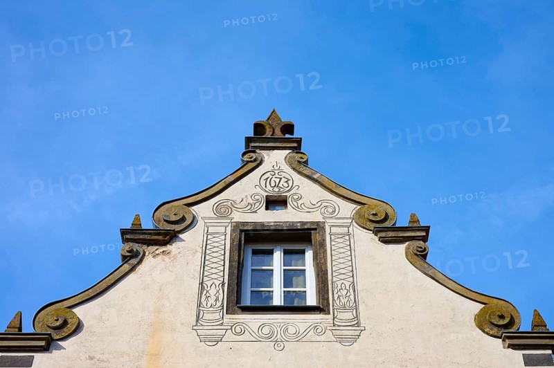 A baroque decorated roof with a central window against a clear blue sky, Wolframs-Eschenbach, Ansbach district, Middle Franconia, Bavaria, Germany