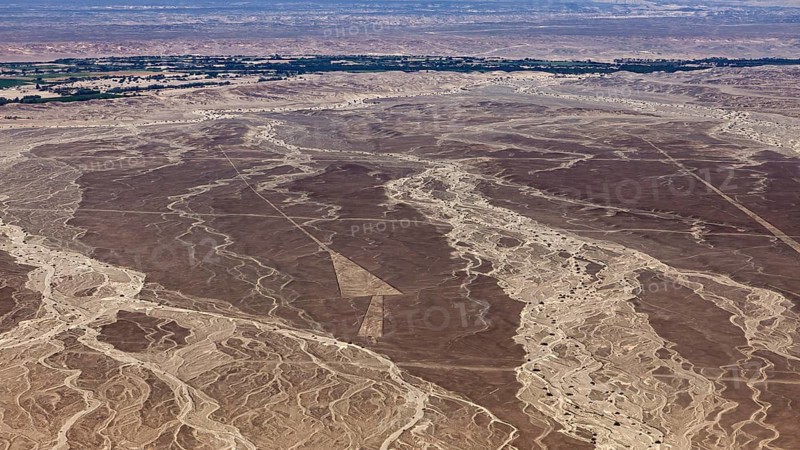Wide desert landscape seen from the air with withered lines and scattered vegetation, the geoglyphs and images in the desert near Nasca and Palpa in Peru