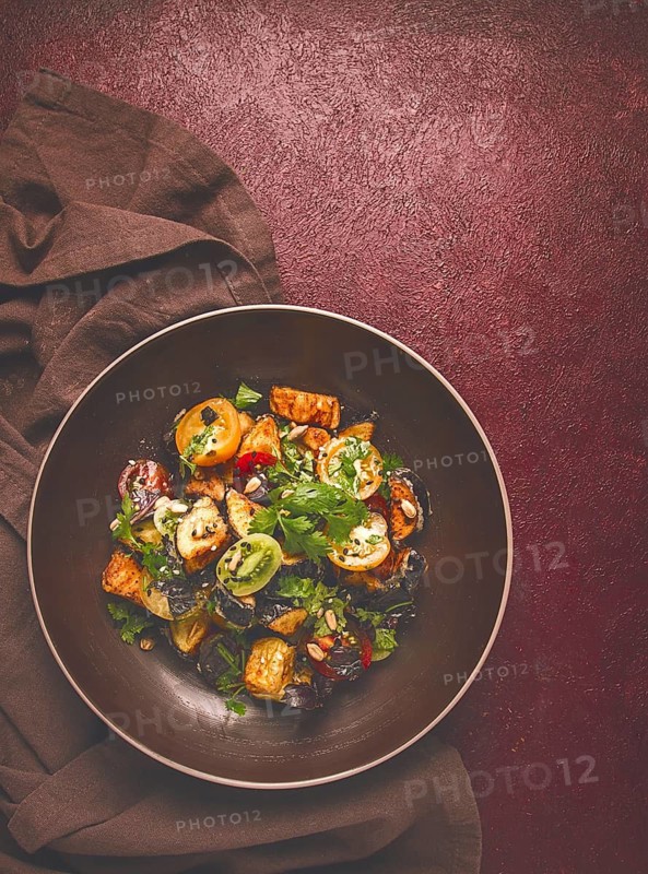 Warm Salad, Saksuka, with crispy eggplant, and tomatoes, spices, herbs, sesame seeds, sunflower seeds, Turkish cuisine, no people