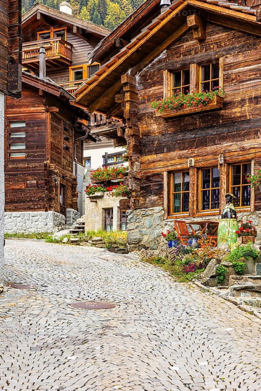Old wooden houses decorated with flowers in the historic village centre, Grimentz, Val d'Anniviers, Valais Alps, Canton Valais, Switzerland
