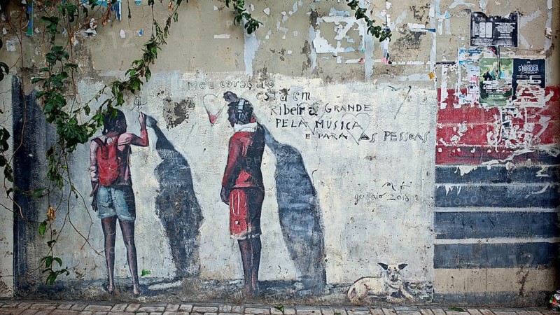 Two people and a dog as silhouettes on a colorful wall full of graffiti, 'pela musica', Ribeira Grande, Santo Antao, Cabo Verde, Cape Verde, Cape Verde
