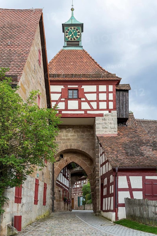Gatehouse with half-timbering and tower clock, Cadolzburg Castle, Bavaria, Germany