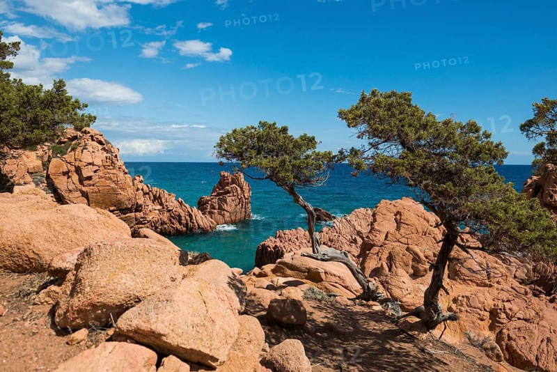 Hiking trail along the coast with red rocks and sea, Spiaggia di Coccorocci, near Tertenia, Province of Ogliastra, Sardinia, Italy