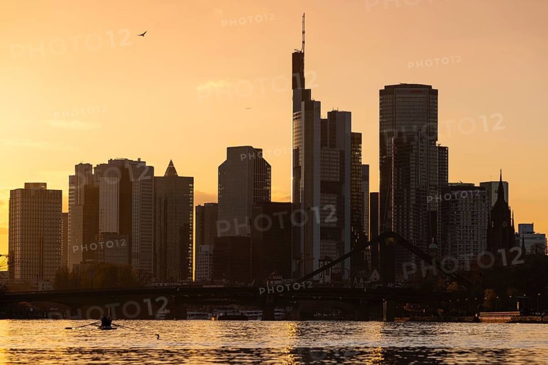 The light of the setting sun falls sideways between the bank towers of the Frankfurt skyline, Frankfurt am Main, Hesse, Germany