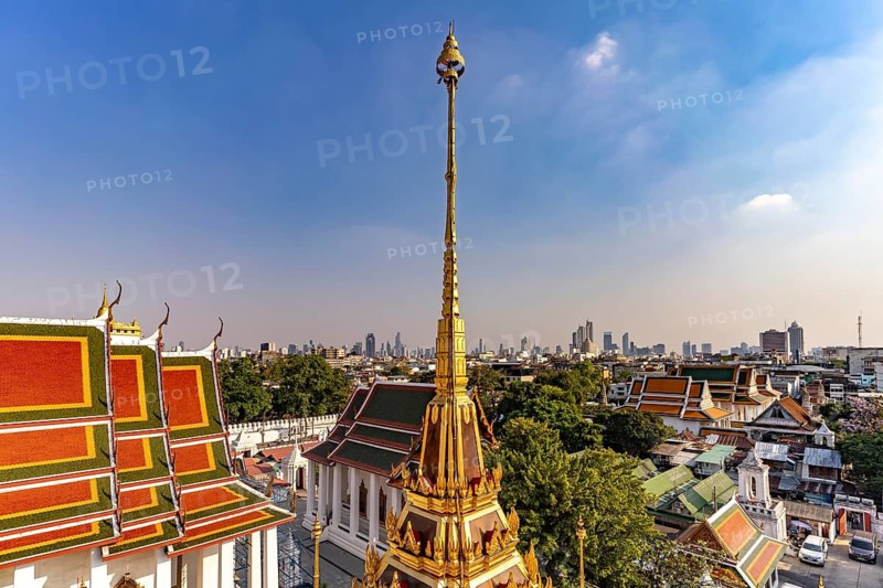 The Buddhist temple complex Wat Ratchanatdaram and the skyline of Bangkok, Thailand