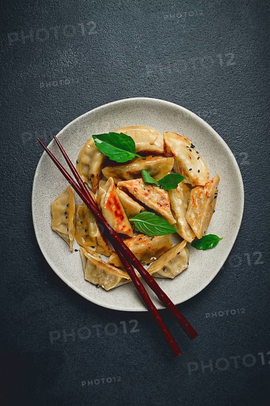 Japanese fried dumplings, gyoza, sesame seeds, top view, no people