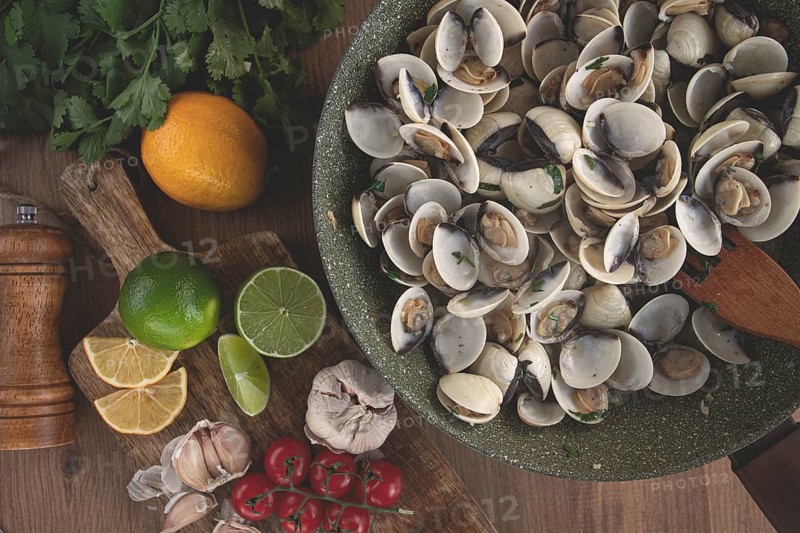Cooking, vongole clams, in a pan with spices and white wine, top view, no people
