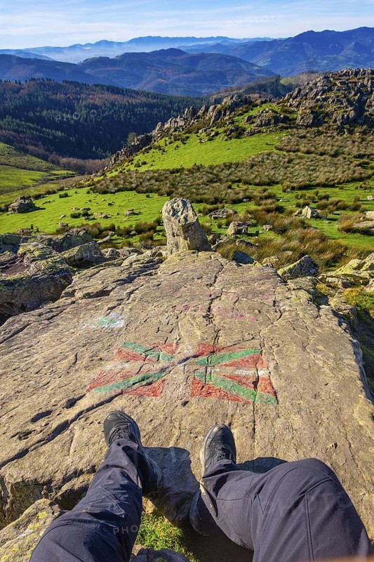 Feet of a man sitting on the top of Mount Adarra in Urnieta. Gipuzkoa, Basque Country