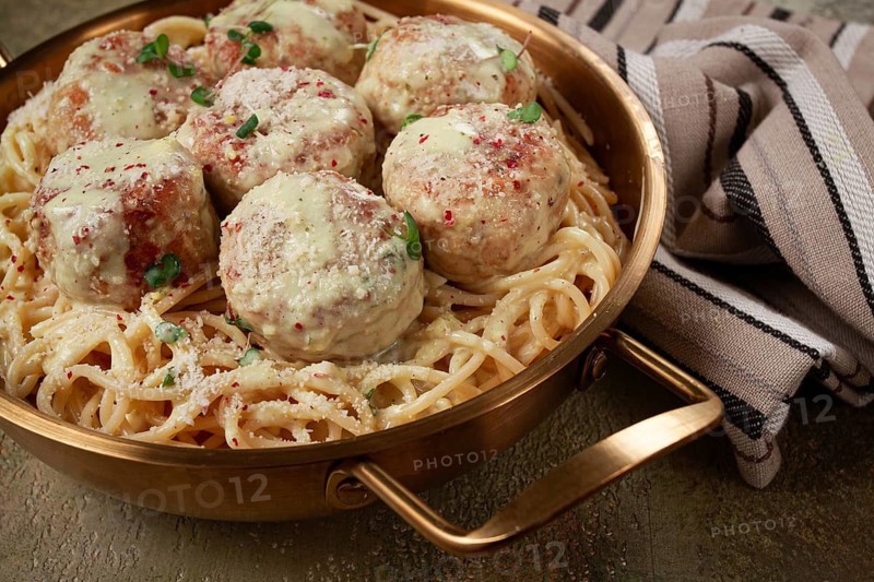 Spaghetti with chicken meatballs, with cream sauce, and parmesan cheese, and decorated with microgreens, homemade, no people