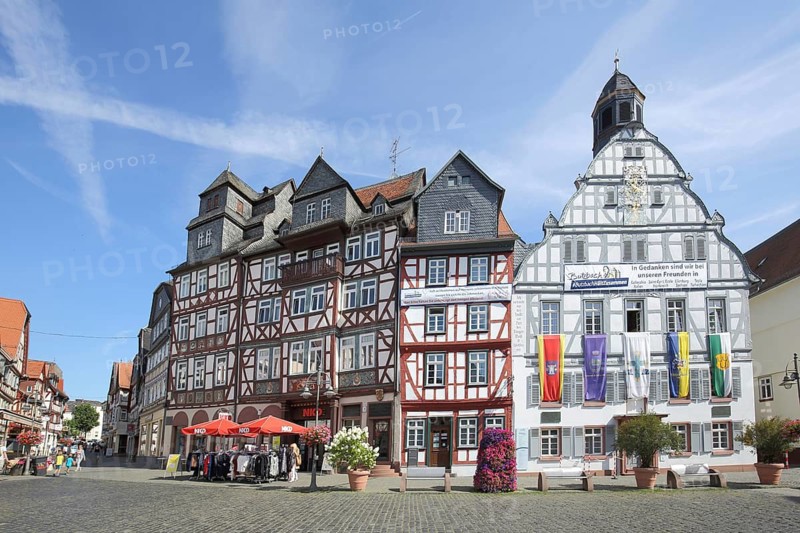 Historic town hall with flags and half-timbered houses, market square, Butzbach, Wetterau, Hesse, Germany