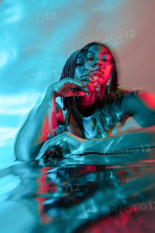 Portrait of a futuristic African young woman immersed in a vibrant, digital metaverse, with neon colors blending seamlessly, creating a dynamic and imaginative atmosphere