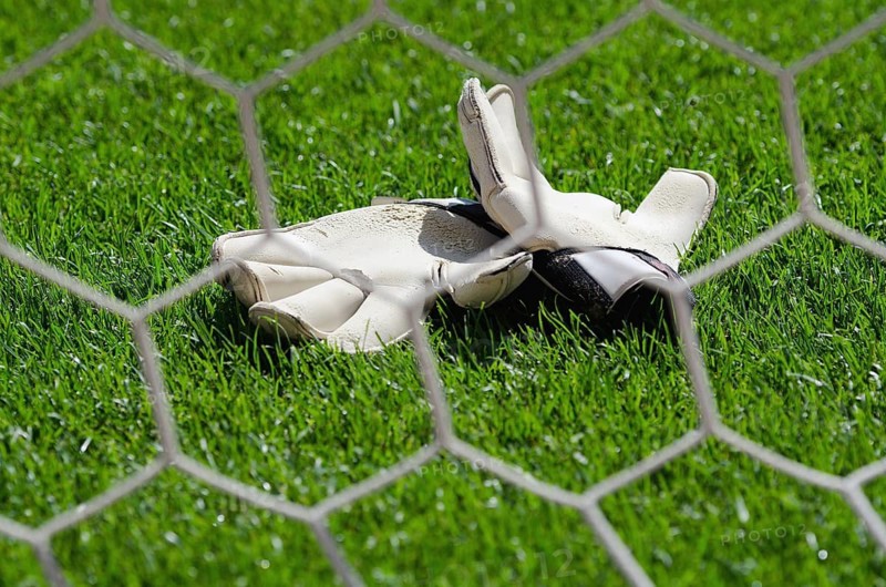 Goalkeeper gloves on the grass on the football field in Wroclaw, Poand